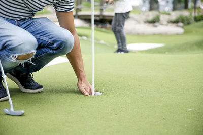 Man playing mini golf