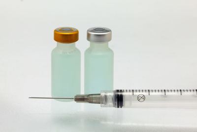 Close-up of bottle on table against white background