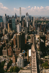 High angle view of modern buildings in city against sky