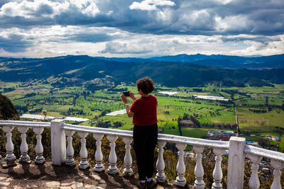 Young woman at a viewpoint over the sopo valley at the department of cundinamarca in colombia