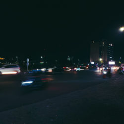 Cars on city street at night