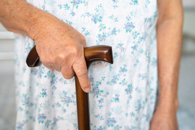 Midsection of woman holding hammer