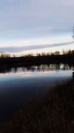 Scenic view of lake against sky during sunset