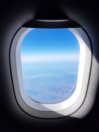 Aerial view of landscape seen through airplane window