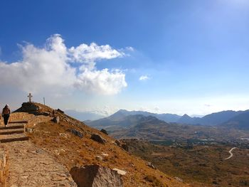 Scenic view of mountains against blue sky