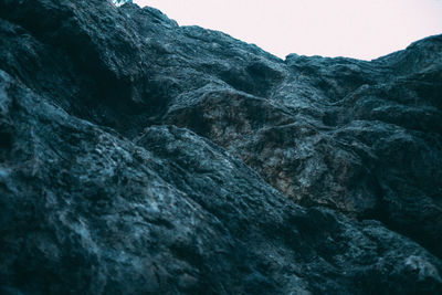 Low angle view of rocks against clear sky