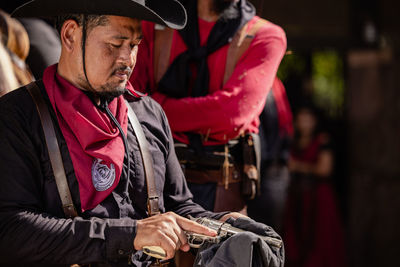 On the ranch, a cowboy prepares for a gunfight