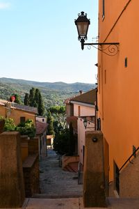 Street amidst buildings in town against sky