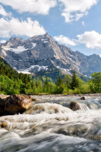 Scenic view of waterfall against sky