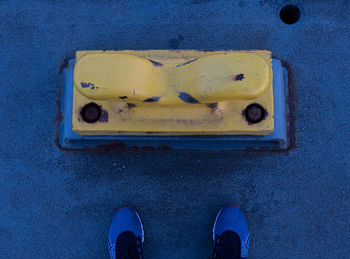 Low section of person standing on metal