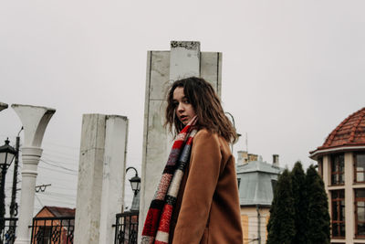 Young woman standing in front of building