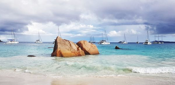 Sailboats on sea against sky