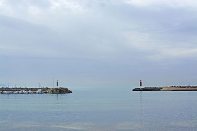 Sailboats on sea against sky