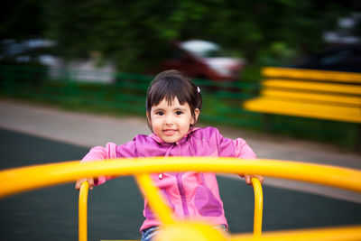 Portrait of happy girl playing in playground