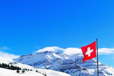 Swiss flag against snow mountain