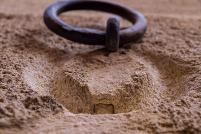 Close-up of iron ring against wall