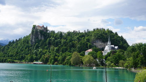 Scenic view of lake by building against sky