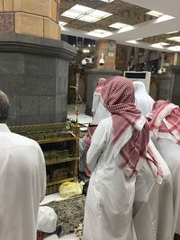 Rear view of men in traditional clothing