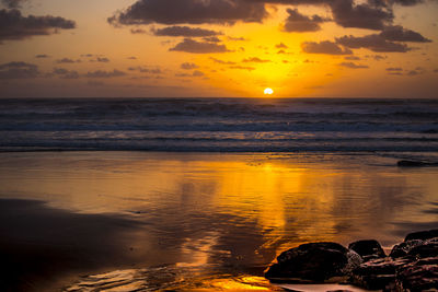 Scenic view of beach at sunset