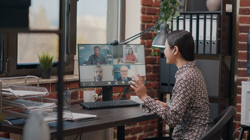 Businesswoman talking on video conference at office