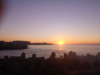 Scenic view of sea against clear sky during sunset