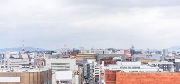 High angle view of buildings in city against sky