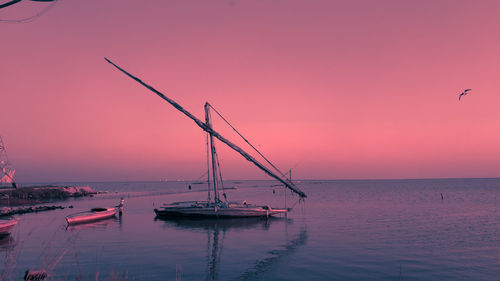 Sailboat on sea against sky during sunset