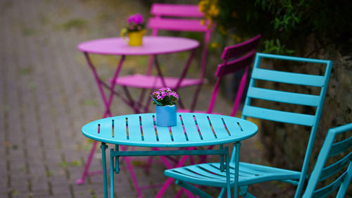 Close-up of empty chairs and table in yard