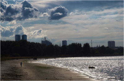 River in city against cloudy sky