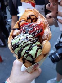 Close-up of hand holding ice cream cone