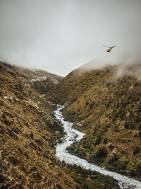 Scenic view of river amidst mountains against cloudy sky at sagarmatha national park