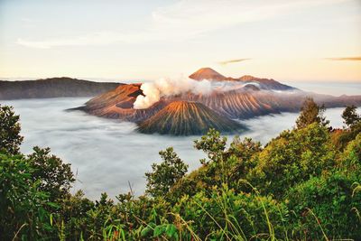 Scenic view of sea and mountains against sky