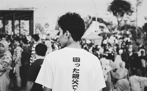 Rear view of young man standing outdoors