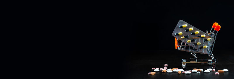 Close-up of illuminated candles against black background