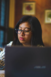 Asian woman working in front of laptop