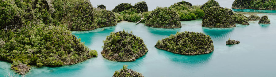 Panoramic view of rocks in water against sky