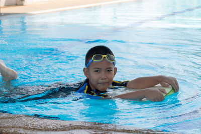 Portrait of boy swimming in pool