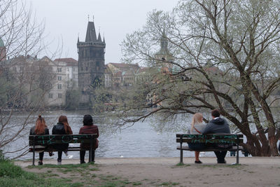 Rear view of man sitting on bench in park