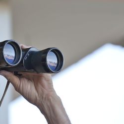 Close-up of human hand holding binoculars