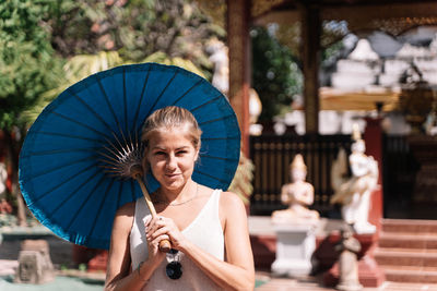 Portrait of woman holding umbrella