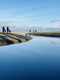 People on beach against sky