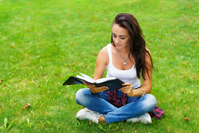 Young woman sitting on field