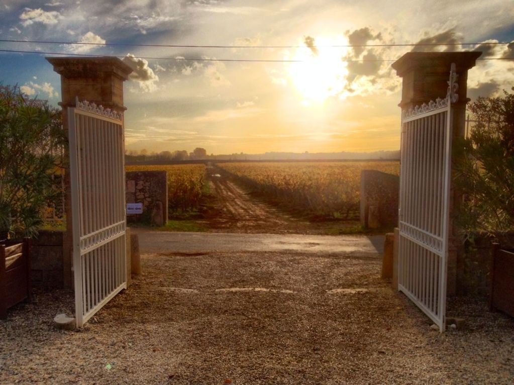 sunset, sky, built structure, the way forward, architecture, cloud - sky, building exterior, sunlight, sun, cloud, tranquility, nature, scenics, tranquil scene, no people, field, orange color, road, landscape, diminishing perspective