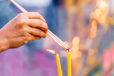 Close-up of hand holding multi colored lights