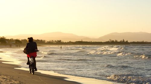 Silhouette of woman standing on beach