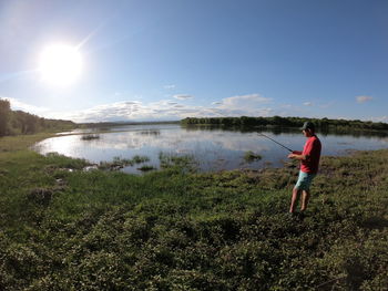 Full length of man on lake against sky