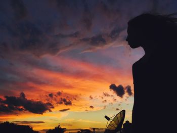 Silhouette of landscape against cloudy sky