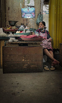 Portrait of woman sitting on table