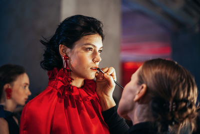 Portrait of woman holding camera