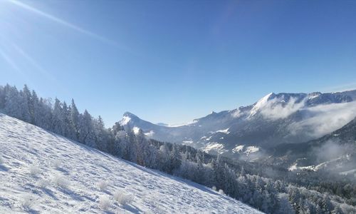 Scenic view of mountains against clear blue sky